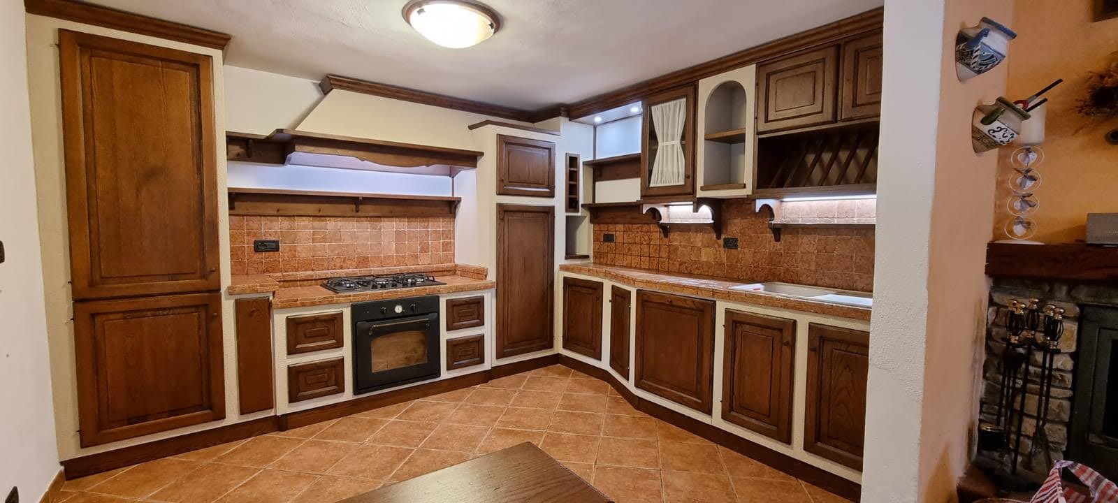 Bespoke handcrafted solid walnut kitchen with terracotta tiles, Cascina Pisa workshop
